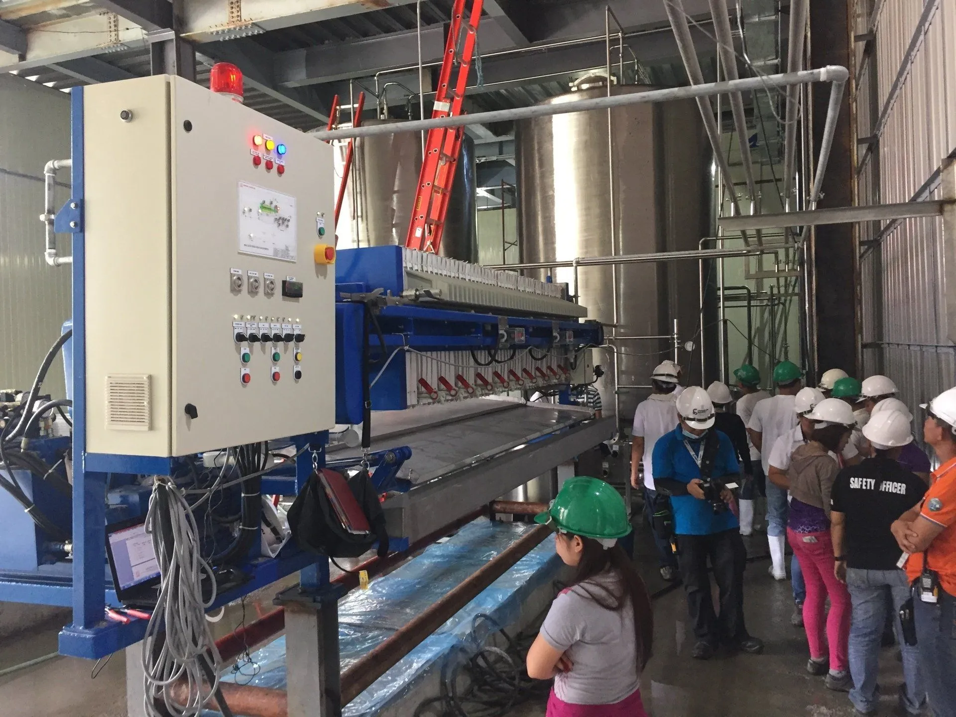 Plant team inspecting a filter press during commissioning